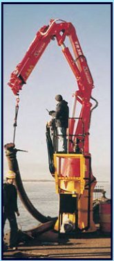 Red Amco Veba crane handling a hose on a dock