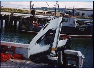 Cormach marine crane on a vessel at a fishing dock