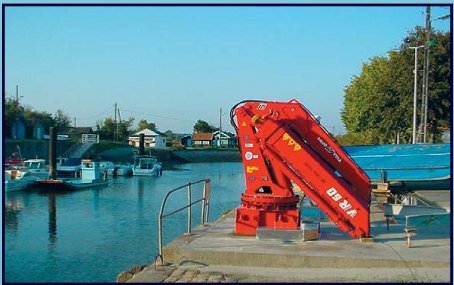 Red pedestal crane on a marina dock