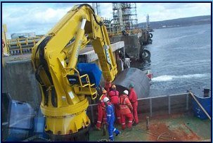 Marine crane working on a vessel deck