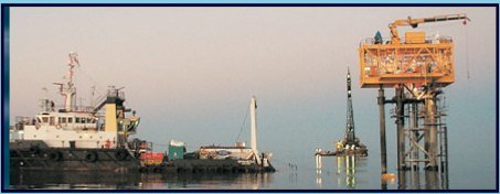 Work vessel beside an offshore platform crane