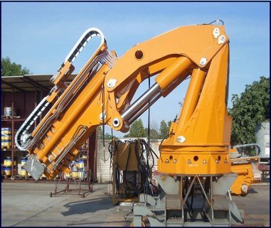 Orange pedestal marine crane in the yard