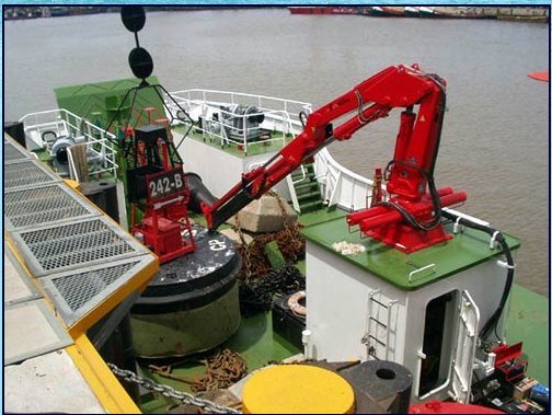 Red marine crane on a ship's foredeck