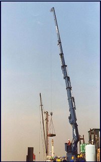 Telescopic crane boom fully extended at a port